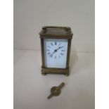 A brass carriage clock with key - Height 13cm - one small chip to glass otherwise good