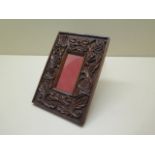 A 19th century arts and crafts carved photo frame - 21cm x 15cm - in polished condition