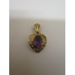 A hallmarked 9ct yellow gold amethyst pendant - 22mm tall - approx weight 1.6 grams - in generally