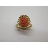 A 22ct yellow gold ring with carved coral centrepiece, size N/O, approx 8.9 grams in good condition