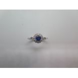 A hallmarked 18ct white gold sapphire and diamond ring size M - head 8mm diameter - in good