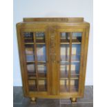 An oak two door glazed Scully display cabinet - Height 126cm x 91cm x 29cm