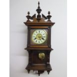 A walnut spring driven striking wall clock - Height 60cm - running order