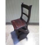 A 20th century metamorphic library chair with brass fittings - in good polished condition