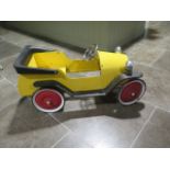 A metal childs pedal car modelled on a bull nose Morris - Length 90cm - in good usable working order