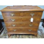 A walnut veneered Georgian style chest with two small over three long drawers - in good clean