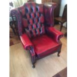 A leather wing back armchair