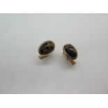 A pair of 9ct yellow gold Tigers eye cufflinks - Head 16mm x 12mm - marked 9ct - total weight approx