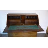 A Georgian mahogany five drawer bureau on ogee bracket feet, 110cm tall x 116cm x 55cm, with a