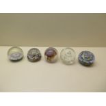 Five glass paper weights including Wedgwood and two Millefiori - some scratches otherwise