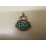 A carved green jade rotating watch fob with gilt plated mount - Width 3cm x Height 4cm - some wear