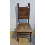A Victorian carved oak side chair with a carved back of musicians in a tavern, 108cm tall x 48cm