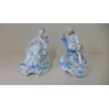 A pair of 19th century continental seated figures of a gallant and companion, 19cm tall, both with