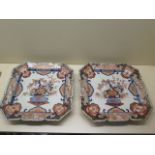 A pair of 19th century Imari square foliate rimmed dishes decorated with a central floral