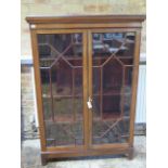 A mahogany astragal glazed two door bookcase with a three adjustable shelves and key - Height