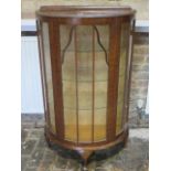 A bowfronted oak 1950's cabinet - Height 122cm x 74cm x 33cm with three glass shelves