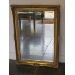 An ornate gilt framed mirror - 91cm x 64cm