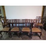A 19th century style pull out mahogany dining table with one leaf on turned reeded legs with six