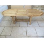 A new Oliver Heartwood Taha single leaf extending hard wood garden table 75cm tall, extends from