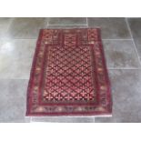 A hand knotted woollen Baluchi rug - 1.20m x 0.92m - in good condition