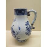 A Chinese 18th century blue and white porcelain jug decorated with blossom and peony - height 27cm -