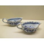 A pair of 19th century oriental blue and white sauce boats - length 20cm - both have chips to rims