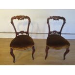 A nice pair of 19th century rosewood side chairs with upholstered seats on cabriole legs