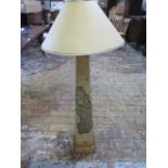 A beautiful gold covered obelisk shaped lampshade with defined intricate pattern and floral design
