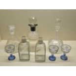 Three cut glass decanters one with silver pourer, a pair of glass cologne bottles - height 18cm -