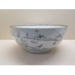 An 18th/19th century black monochrome bowl decorated with landscape, buildings, birds, ships and