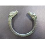 A bronze bangle of a Viking design with a green patina finish - 9cm x 8cm