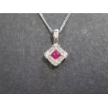A fine quality ruby baguette and brilliant cut diamond pendant on an 18ct white gold chain - chain