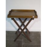 An Edwardian/early 20th century oak butlers tray with X folding support - width 70cm x depth 47cm
