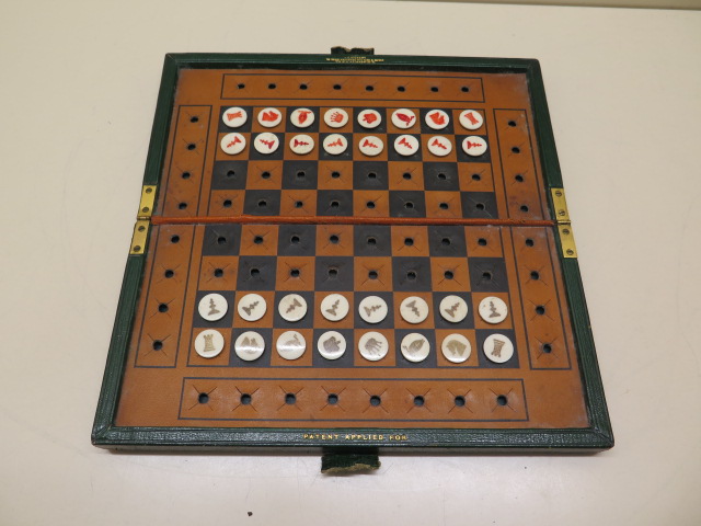 A good quality Edwardian leather bound travelling chess set by JC Vickery with bone button chess