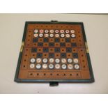 A good quality Edwardian leather bound travelling chess set by JC Vickery with bone button chess