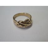 A yellow gold puzzle ring - tests to above 9ct - ring size M - approx weight 4.3 grams - in