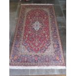 A hand knotted woollen fine Kashan rug - 2.05m x 1.40m - in good condition