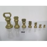 Seven graduating brass weights - tallest is 9cm high, from 1lb down