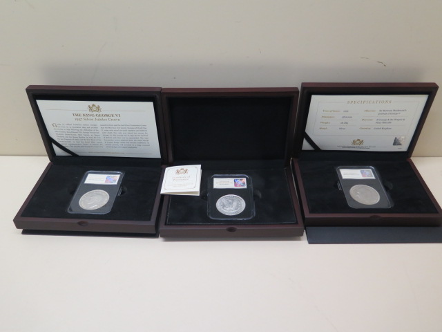 Three boxed silver coins - 1921 Morgan Dollar, 1937 George VI Coronation Crown and a 1935 George V