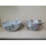 A pair of Oriental bowls decorated with birds and flowers - 14cm and 15cm tall, 33cm and 31cm