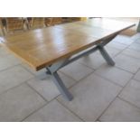 A Bramblecrest extendable dining table with an oak top and painted X frame base - extends from 180cm