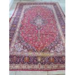 A red ground Persian Kashan carpet with traditional medallion design made in corker wool - 3.70m x