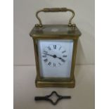 An 8 day brass carriage clock with key, 11 cm high, working