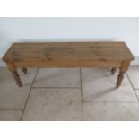 A new rustic pine bench on turned legs, 46cm tall x 129cm x 32cm