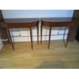 A pair of 19th century style mahogany D shaped side tables each with a blind drawer on turned reeded