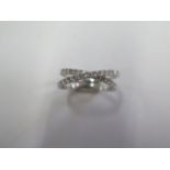 An 18ct white gold diamond crossover ring marked 750 size J/K - approx weight 2.2 grams - in