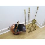 A copper helmet coal scuttle with three brass fire irons and two rests - all in polished usable