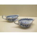 A pair of 19th century oriental blue and white sauce boats - length 20cm - both have chips to rims