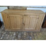 A Victorian stripped pine two door cupboard, 87cm tall x 158cm x 50cm, condition consistent with age