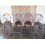 A near set of four Victorian ash and elm hoop back kitchen chairs in good condition with normal wear